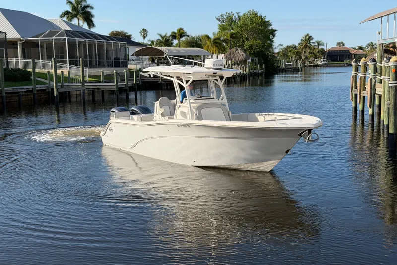 Slide: The Image of 2022 Sea Fox 288 Commander boat cruising in a calm residential canal. - 32