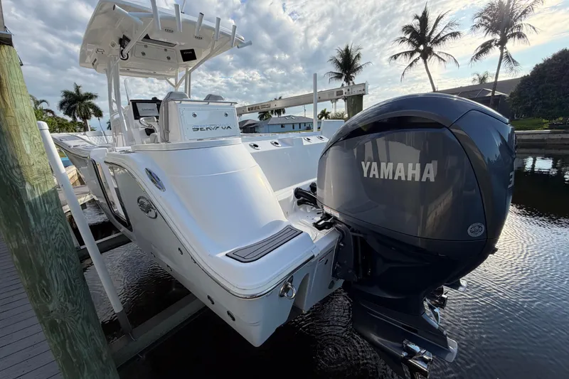 Slide: The Image of 2022 Sea Fox 288 Commander boat with Yamaha engine docked by palm trees. - 35