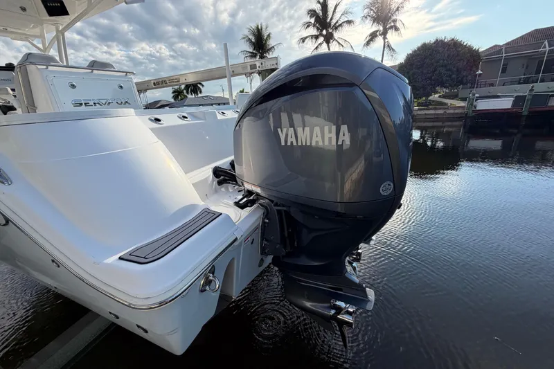 Slide: The Image of 2022 Sea Fox 288 Commander boat with Yamaha outboard motor, docked by palm trees. - 36
