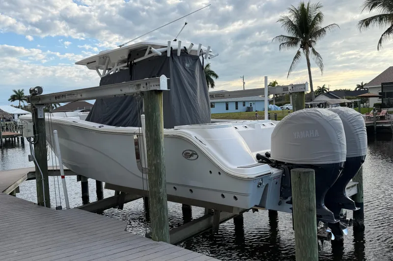 Slide: The Image of 2022 Sea Fox 288 Commander boat docked with Yamaha engines, palm trees in background. - 38