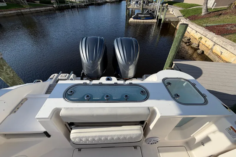 Slide: The Image of 2022 Sea Fox 288 Commander boat with dual engines docked by a serene waterfront. - 54