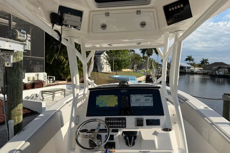 Slide: The Image of 2022 Sea Fox 288 Commander boat interior with navigation system, docked by a canal. - 57
