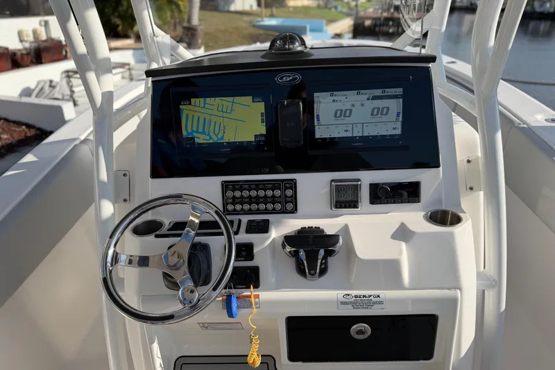 Slide: The Image of 2022 Sea Fox 288 Commander dashboard with navigation screens and steering wheel. - 58