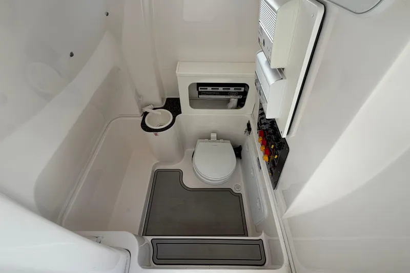 Slide: The Image of Interior of 2022 Sea Fox 288 Commander boat bathroom with toilet and control panel. - 63