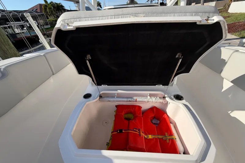 Slide: The Image of Open storage compartment on 2022 Sea Fox 288 Commander boat with life jackets inside. - 64
