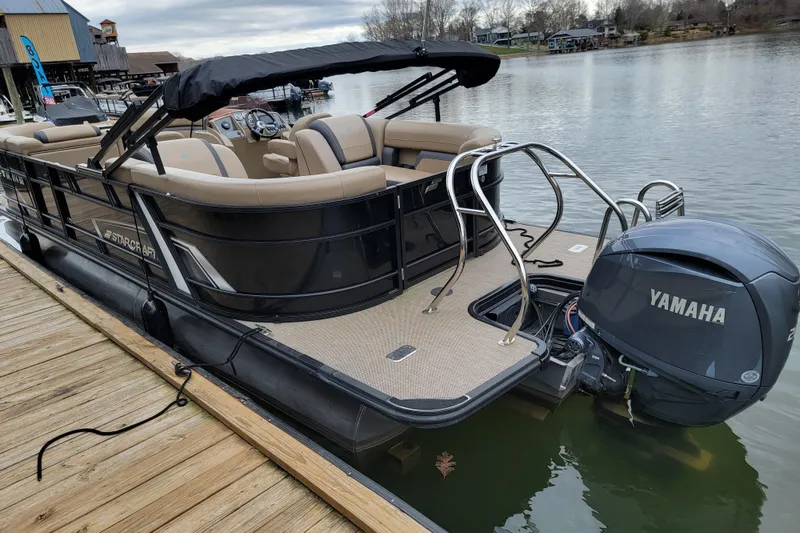 Slide: The Image of 2024 Starcraft EXS 3 pontoon boat docked, featuring Yamaha outboard motor. - 4