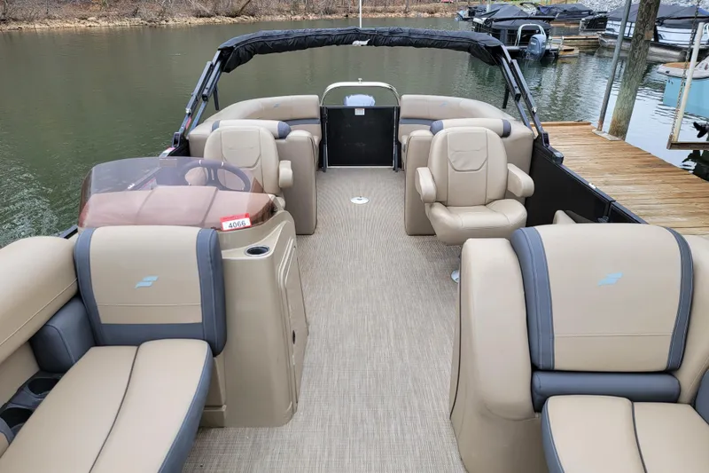 Slide: The Image of 2024 Starcraft EXS 3 pontoon boat interior with beige seating and lake view. - 5