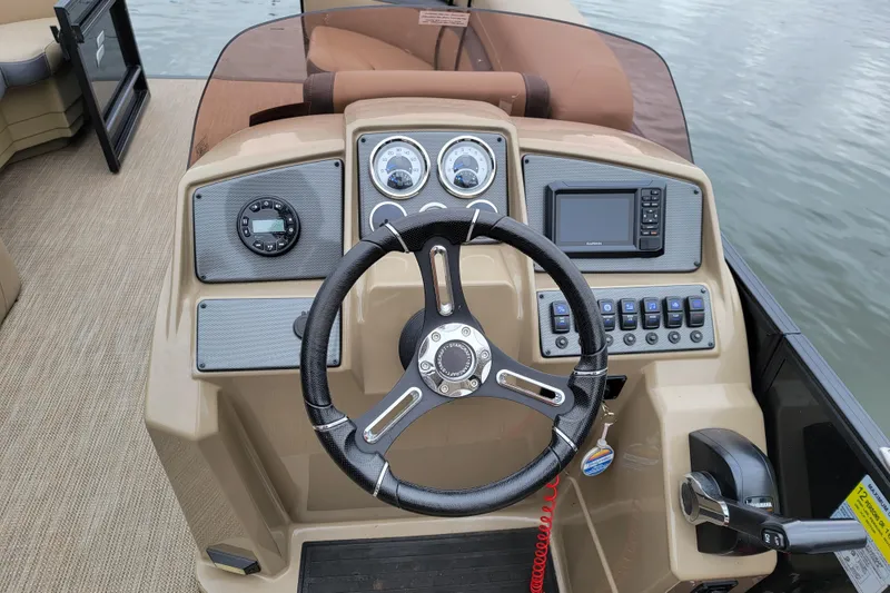 Slide: The Image of 2024 Starcraft EXS 3 boat dashboard with steering wheel and control panel. - 7