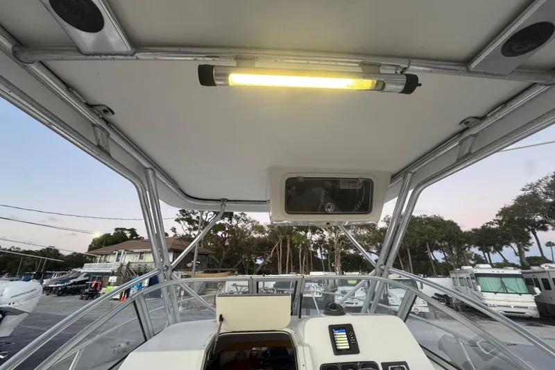Slide: The Image of 2006 Century 2400 Walk-Around boat interior with overhead light and control panel. - 11