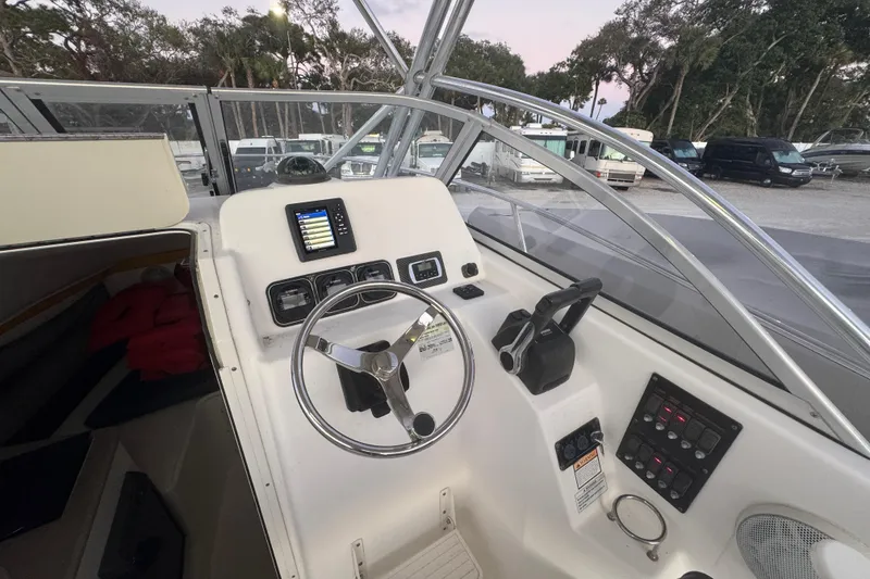 Slide: The Image of Century 2400 Walk-Around 2006 boat cockpit with steering wheel and control panel. - 12