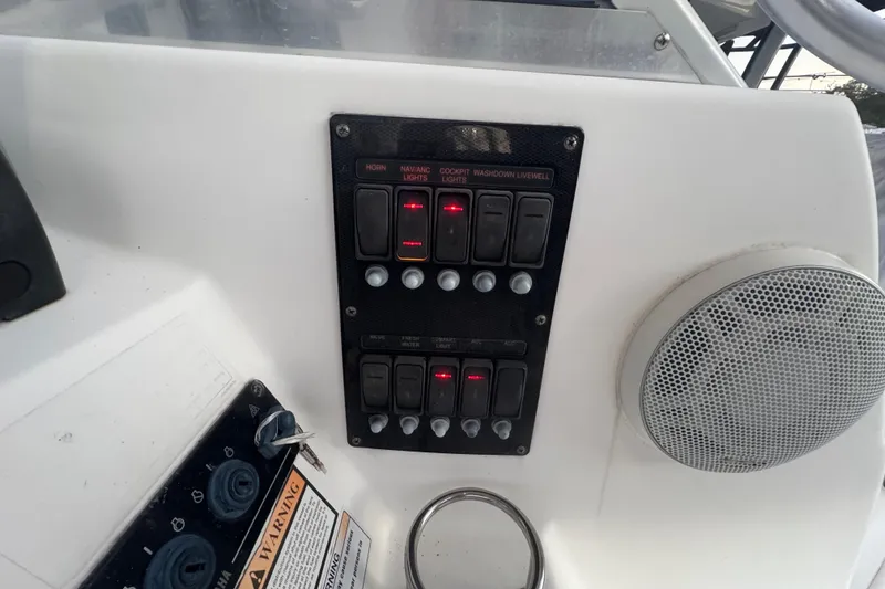 Slide: The Image of Control panel of a 2006 Century 2400 Walk-Around boat with switches and speaker. - 13