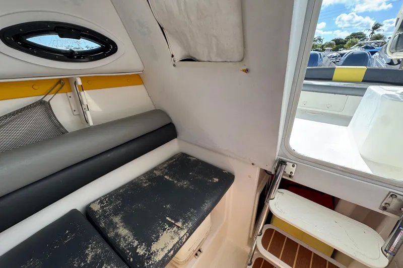 Slide: The Image of Interior cabin of a 2006 Century 2400 Walk-Around boat with seating and porthole. - 19
