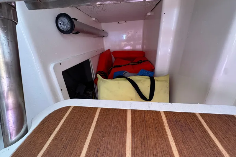 Slide: The Image of Interior storage of 2006 Century 2400 Walk-Around boat with bags and equipment. - 21