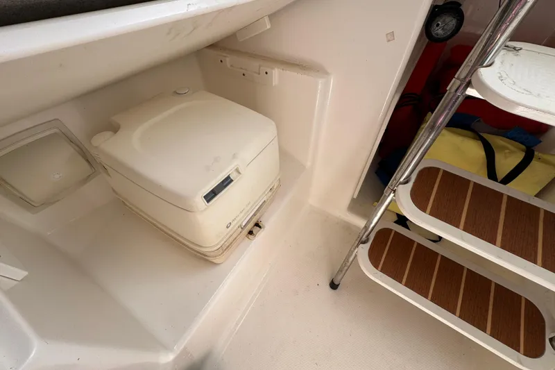 Slide: The Image of 2006 Century 2400 Walk-Around cabin interior with portable toilet and ladder. - 22