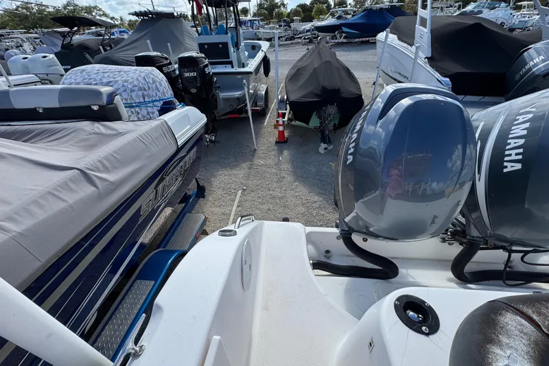 Slide: The Image of Boats in a marina, featuring a 2006 Century 2400 Walk-Around with Yamaha engines. - 24