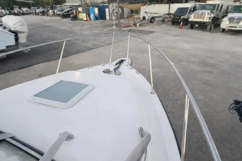 Slide: The Image of 2006 Century 2400 Walk-Around boat deck view at a marina. - 26