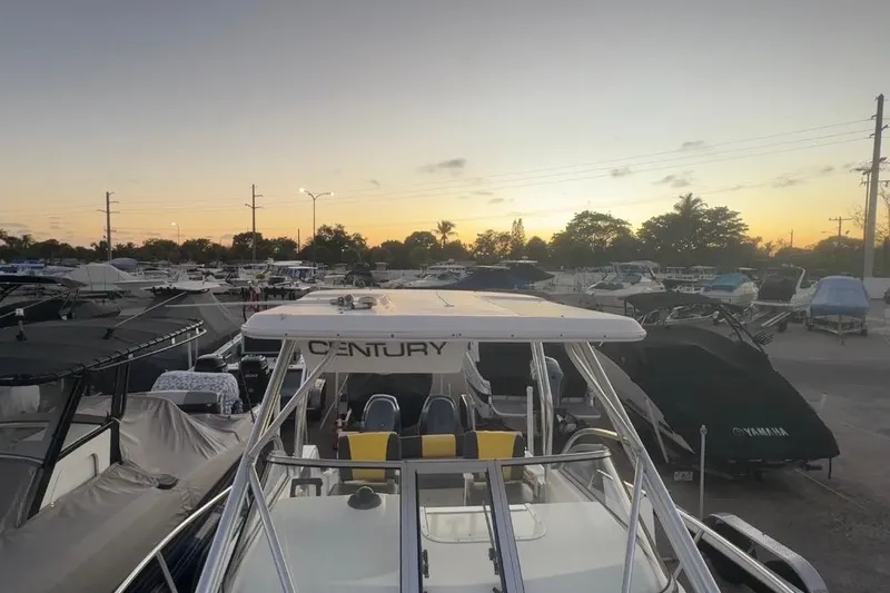 Slide: The Image of 2006 Century 2400 Walk-Around boat at sunset in a marina. - 27