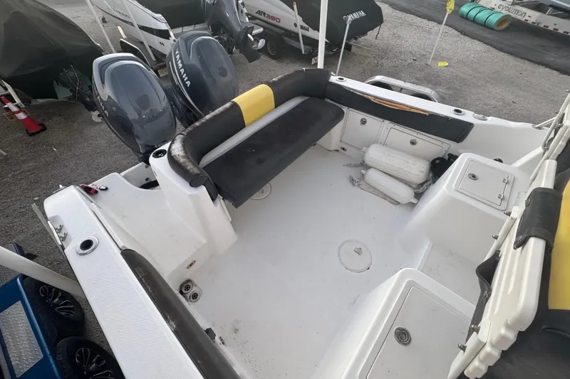 Slide: The Image of 2006 Century 2400 Walk-Around boat interior with Yamaha engines, featuring seating and storage compartments. - 5