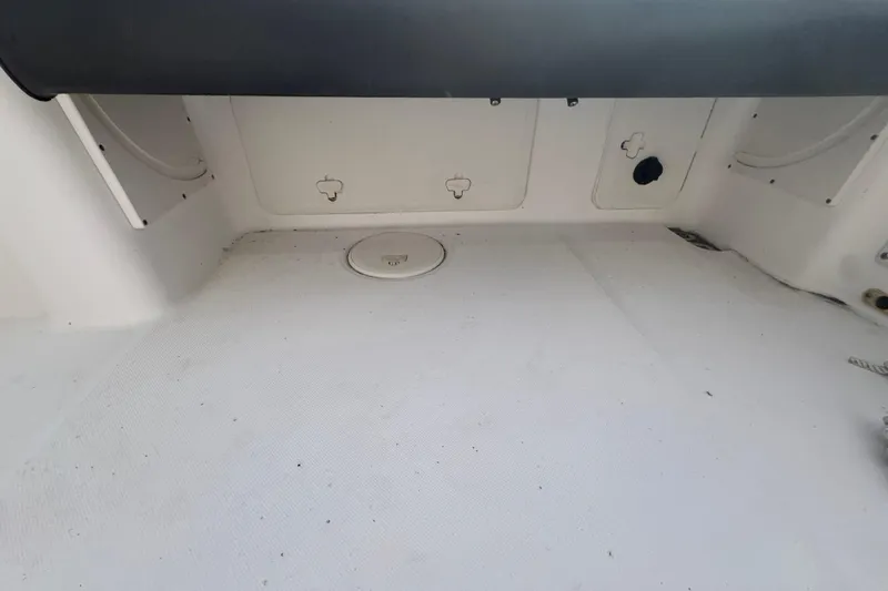 Slide: The Image of 2006 Century 2400 Walk-Around boat interior, featuring storage compartments and clean deck space. - 7