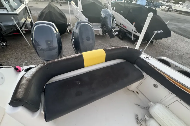 Slide: The Image of 2006 Century 2400 Walk-Around boat with dual outboard motors and cushioned seating. - 8