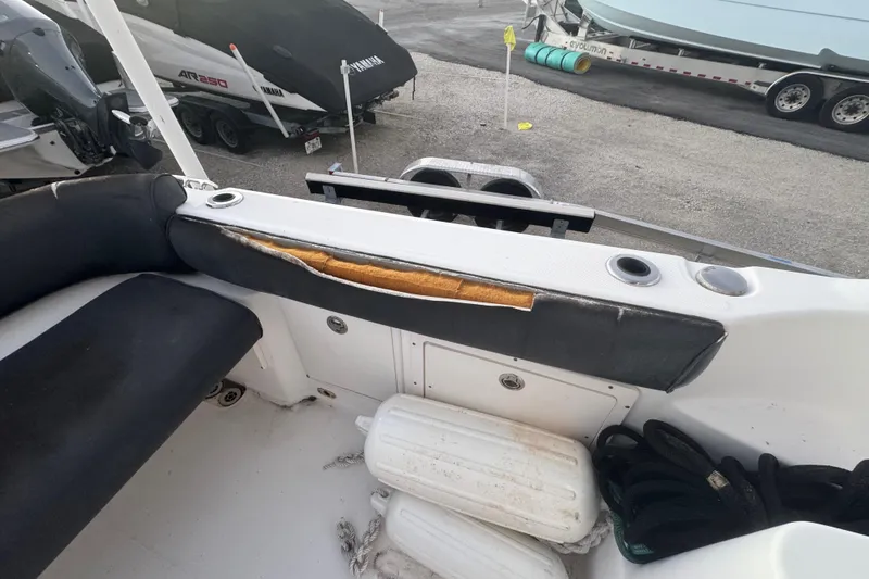 Slide: The Image of 2006 Century 2400 Walk-Around boat interior with damaged upholstery and storage compartments. - 9