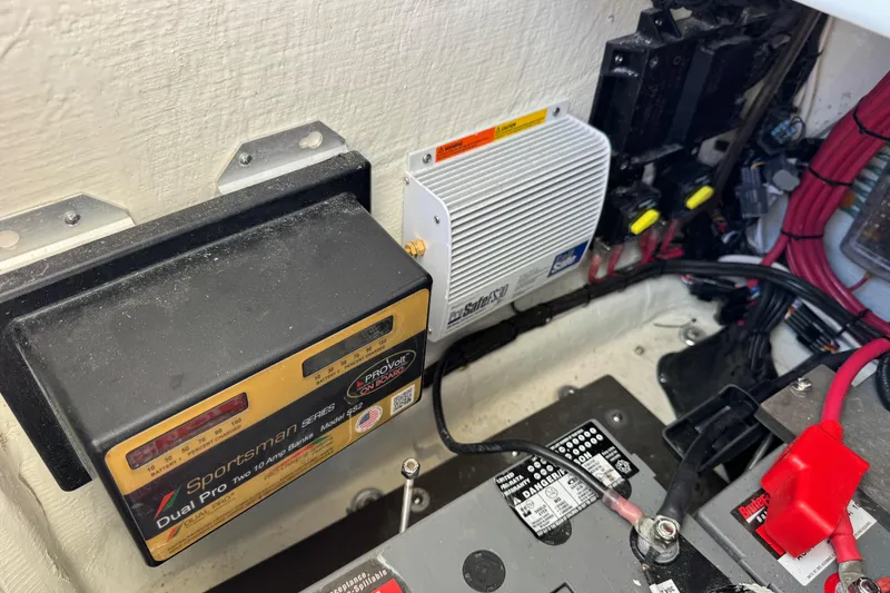 Slide: The Image of Electrical components and wiring inside a 2023 Contender 26 Bay boat. - 12