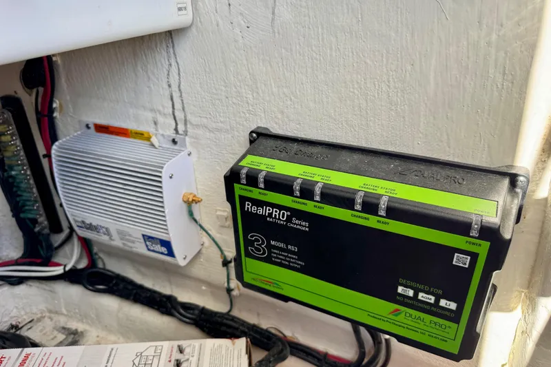 Slide: The Image of Battery charger and electrical components inside a 2023 Contender 26 Bay boat. - 13