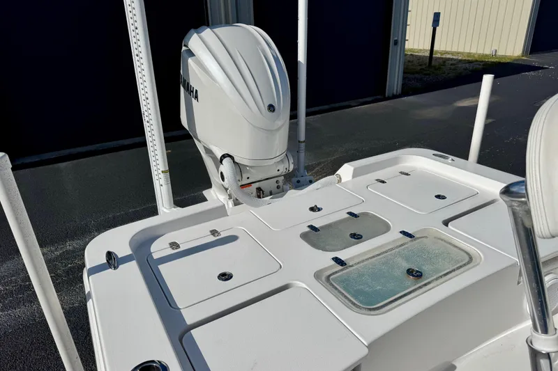 Slide: The Image of 2023 Contender 26 Bay boat with Yamaha outboard motor, featuring storage compartments. - 15