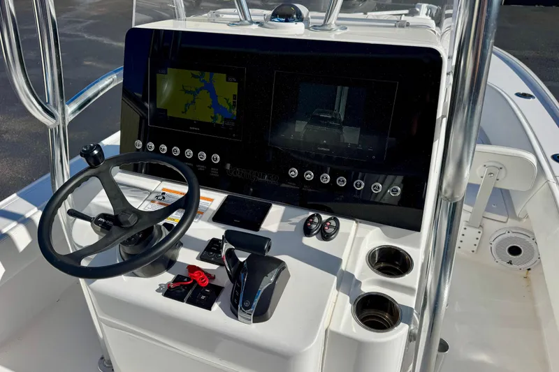 Slide: The Image of 2023 Contender 26 Bay boat console with steering wheel and navigation screens. - 17