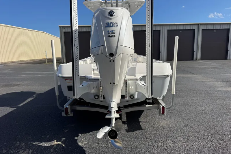 Slide: The Image of 2023 Contender 26 Bay boat with Yamaha 300 V6 engine, parked outdoors. - 5