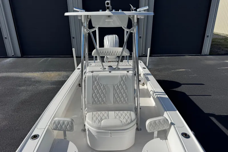 Slide: The Image of 2023 Contender 26 Bay boat with sleek design and cushioned seating. - 7