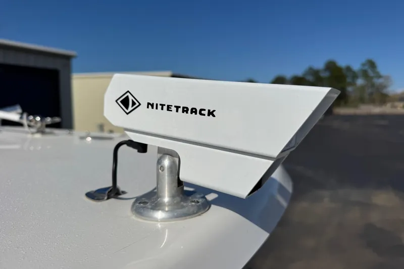 Slide: The Image of NITETRACK device mounted on 2023 Contender 26 Bay boat under clear blue sky. - 8
