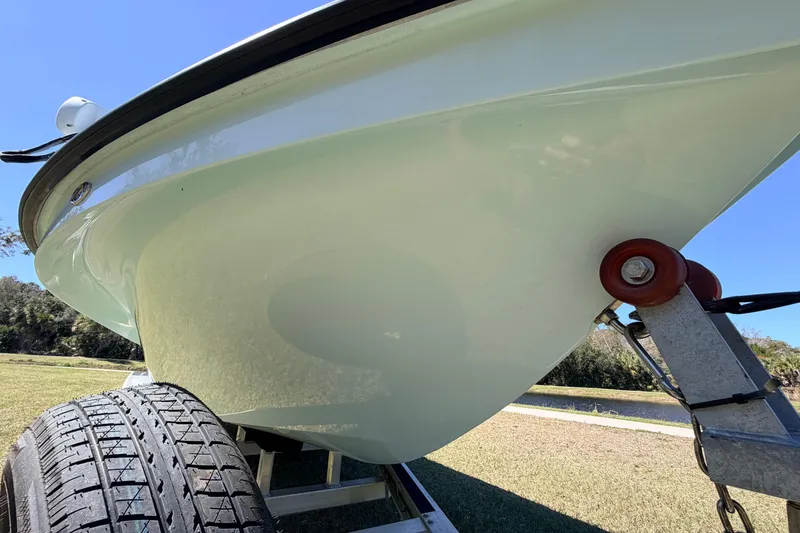 Slide: The Image of 2023 East Cape 18 EVO X boat on trailer, close-up view of hull and tire. - 12
