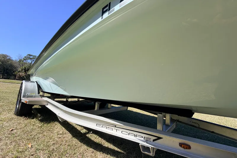 Slide: The Image of 2023 East Cape 18 EVO X boat on trailer, side view, outdoors. - 13