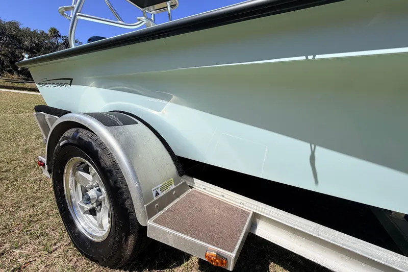 Slide: The Image of 2023 East Cape 18 EVO X boat on trailer, side view in outdoor setting. - 15