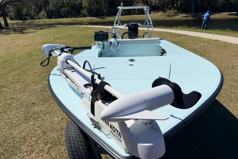Slide: The Image of 2023 East Cape 18 EVO X boat with trolling motor on grassy area. - 30