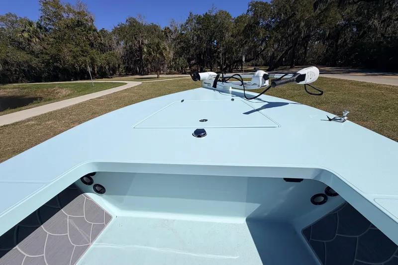 Slide: The Image of 2023 East Cape 18 EVO X boat with trolling motor on grassy area. - 31