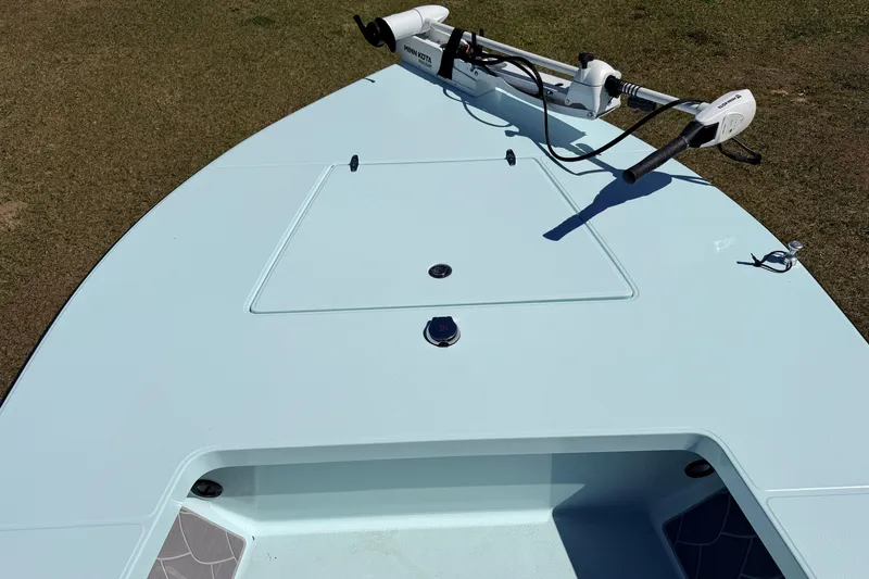 Slide: The Image of 2023 East Cape 18 EVO X boat deck with trolling motor, on grass. - 32