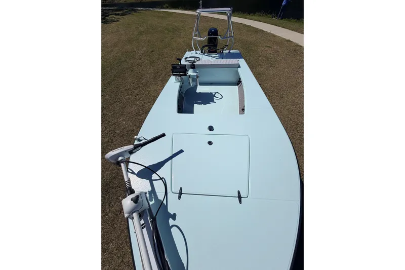 Slide: The Image of 2023 East Cape 18 EVO X boat on grass, showcasing deck and equipment. - 36