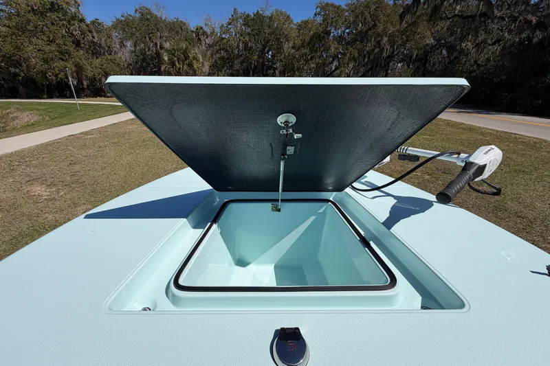 Slide: The Image of 2023 East Cape 18 EVO X boat hatch open, showcasing storage compartment. - 39