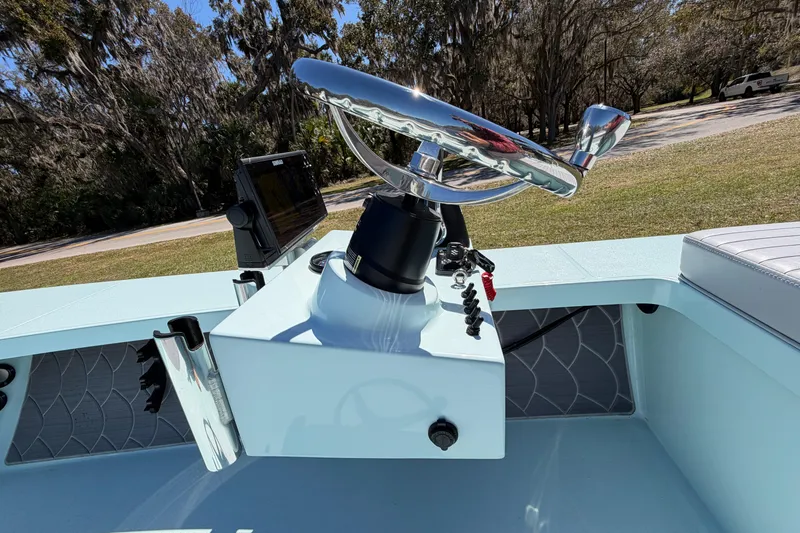 Slide: The Image of 2023 East Cape 18 EVO X boat console with steering wheel and navigation display. - 47