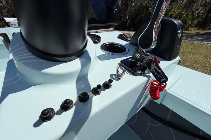 Slide: The Image of 2023 East Cape 18 EVO X boat console with controls and switches. - 49