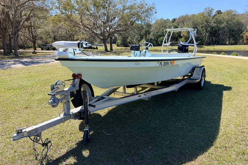 Slide: The Image of 2023 East Cape 18 EVO X boat on trailer in grassy park setting. - 5