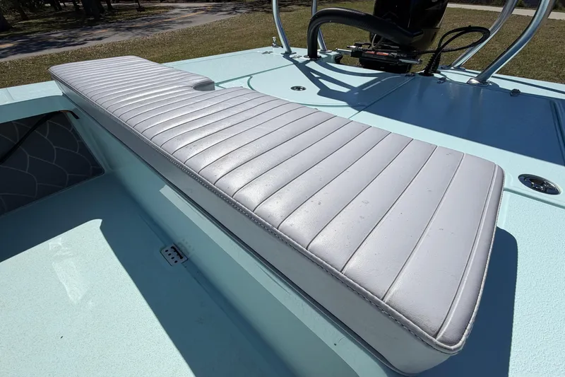 Slide: The Image of 2023 East Cape 18 EVO X boat with white cushioned seating and light blue deck. - 56