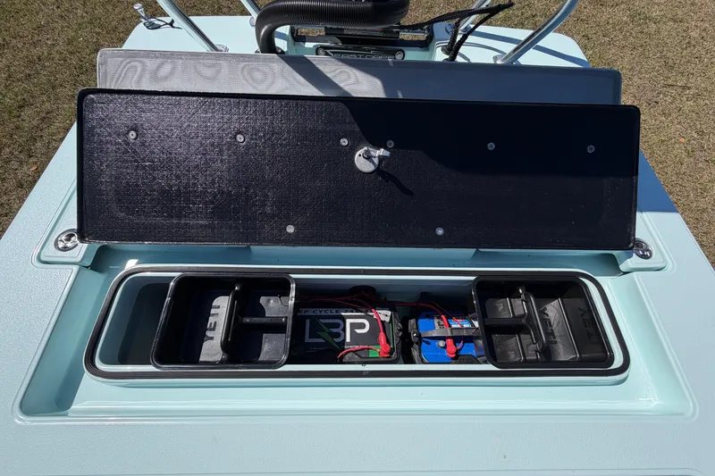 Slide: The Image of 2023 East Cape 18 EVO X boat storage compartment with battery setup. - 59