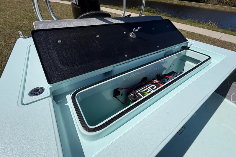 Slide: The Image of Open storage compartment of 2023 East Cape 18 EVO X boat, showcasing interior details. - 60