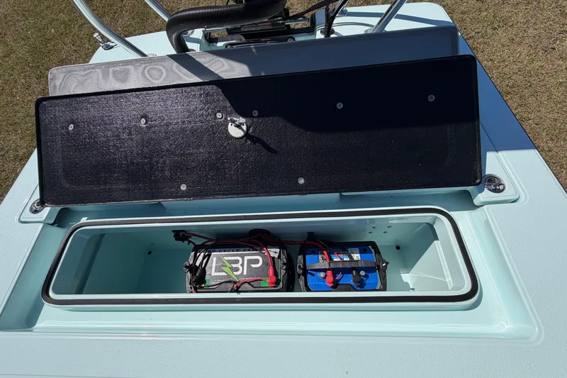 Slide: The Image of Open storage compartment of 2023 East Cape 18 EVO X boat with batteries inside. - 64