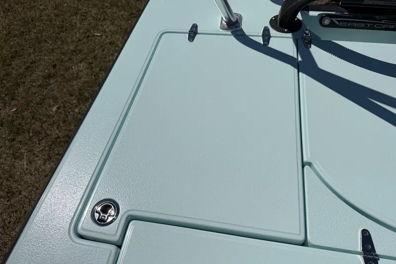 Slide: The Image of 2023 East Cape 18 EVO X boat deck with latch and hinges in sunlight. - 65