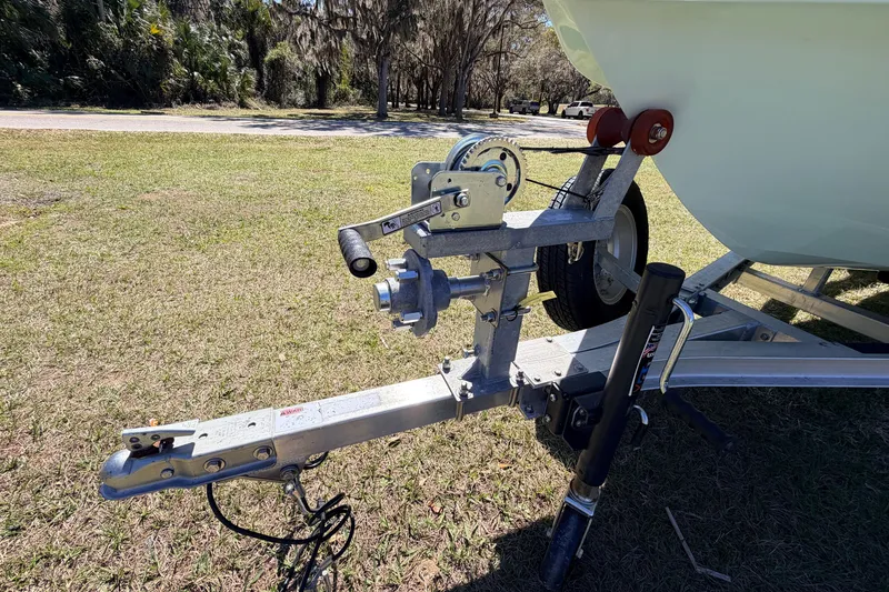 Slide: The Image of Trailer hitch and winch of 2023 East Cape 18 EVO X boat on grassy area. - 7