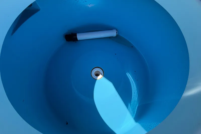 Slide: The Image of Blue interior of 2023 East Cape 18 EVO X boat with a drain plug. - 71